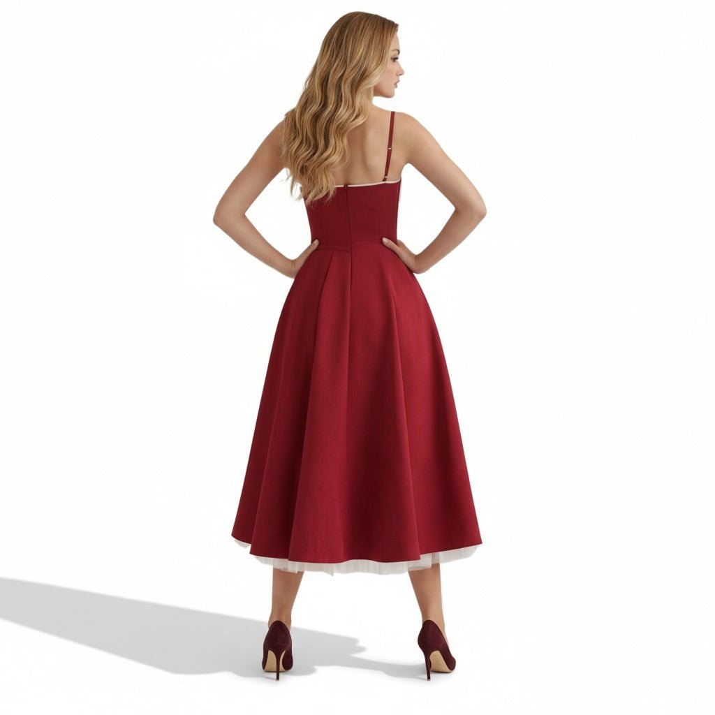 Back view of a burgundy midi dress with open back, fitted waist, and full skirt