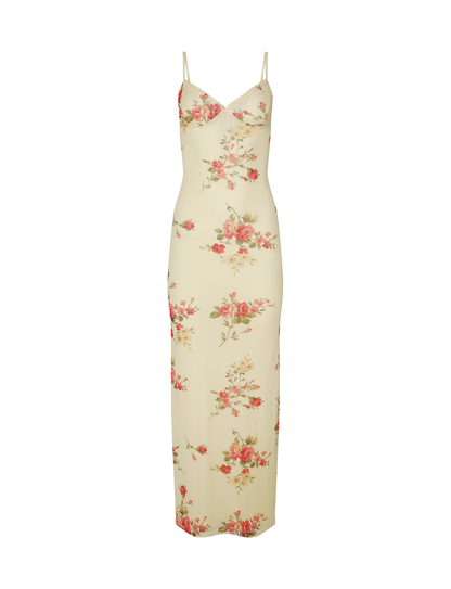 The TIGERMIST JULIANNA DRESS is a sleeveless, floor-length yellow maxi dress with macro and pop floral prints, adjustable spaghetti straps, a fitted silhouette, and a subtle v-neckline.
