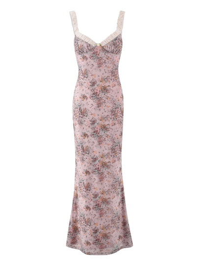 The AMARAN DRESS - PINK : CAMO FLORAL by TIGERMIST is a long, sleeveless bodycon maxi dress with ruffled straps and neckline, featuring a charming pink camo floral vintage-style pattern.