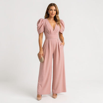 Pink wide leg jumpsuit with puff sleeves, deep V-neck, and cinched waist