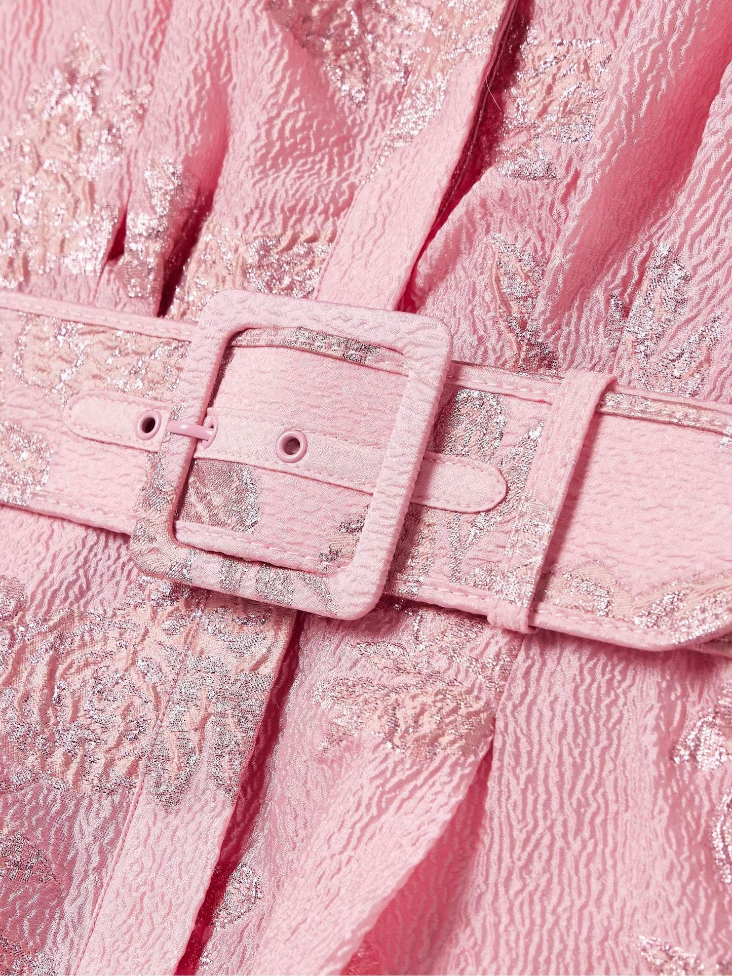 Close-up of pink belted maxi dress showing textured floral fabric and buckle detail