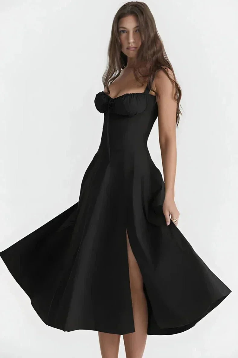 Black midi dress with spaghetti straps, ruched bust, and thigh-high slit for a fitted summer dress look