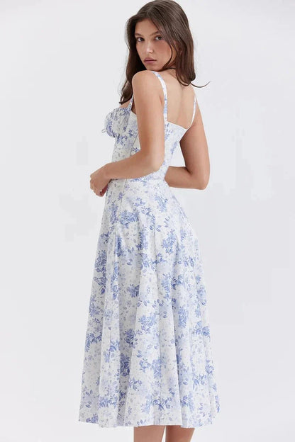 Side view of blue floral midi dress showing fitted waist, straps, and flowing skirt