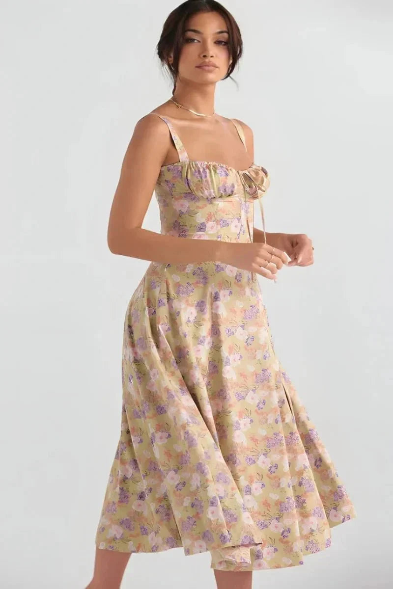 Front view of yellow floral midi dress with ruched bust, fitted waist, and flared skirt