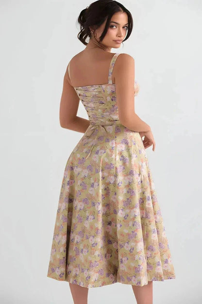 Back view of yellow floral midi dress with open back, straps, and gathered waist