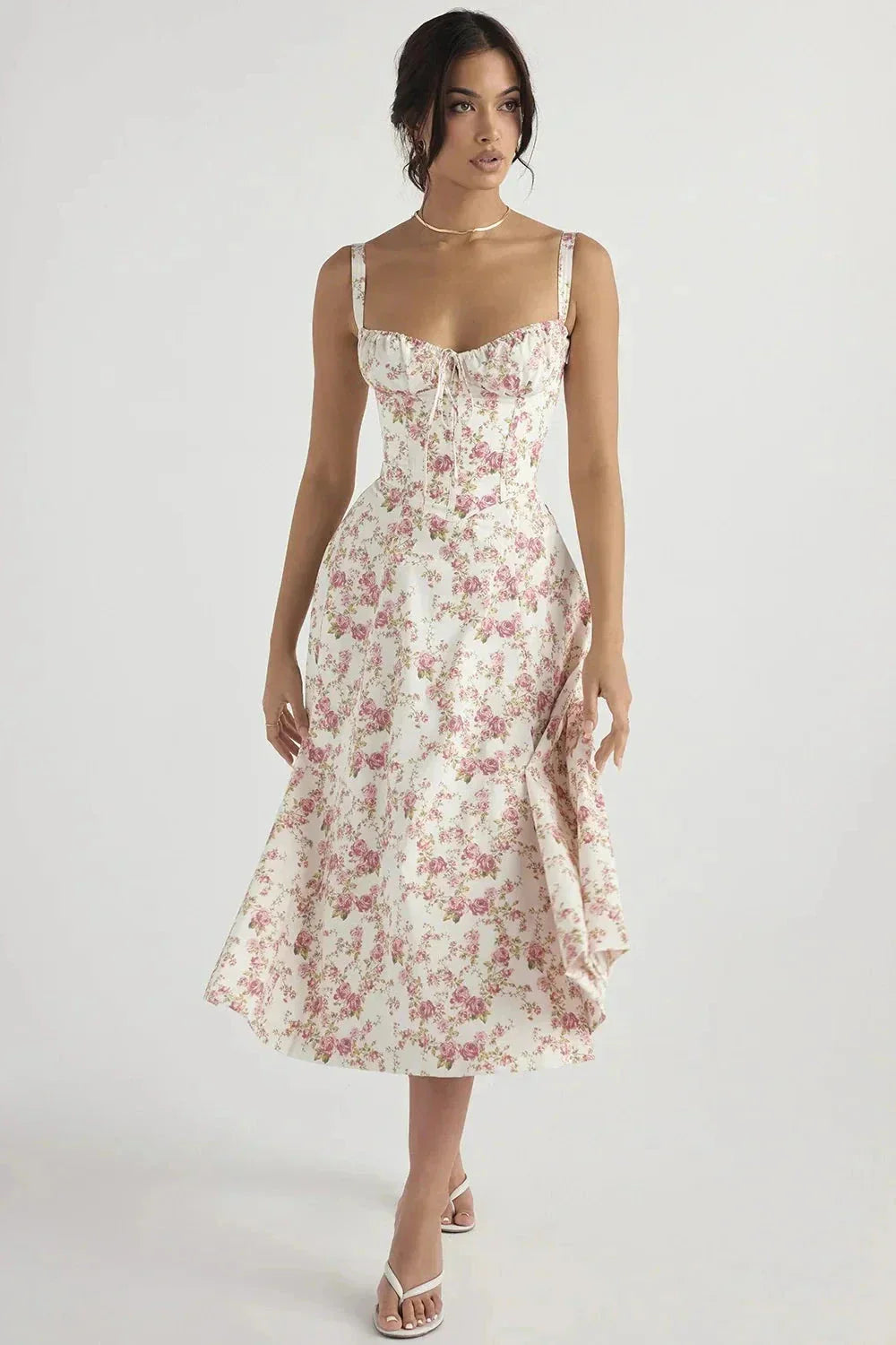 White floral midi dress with pink print, sweetheart neckline, and fitted corset-style bodice