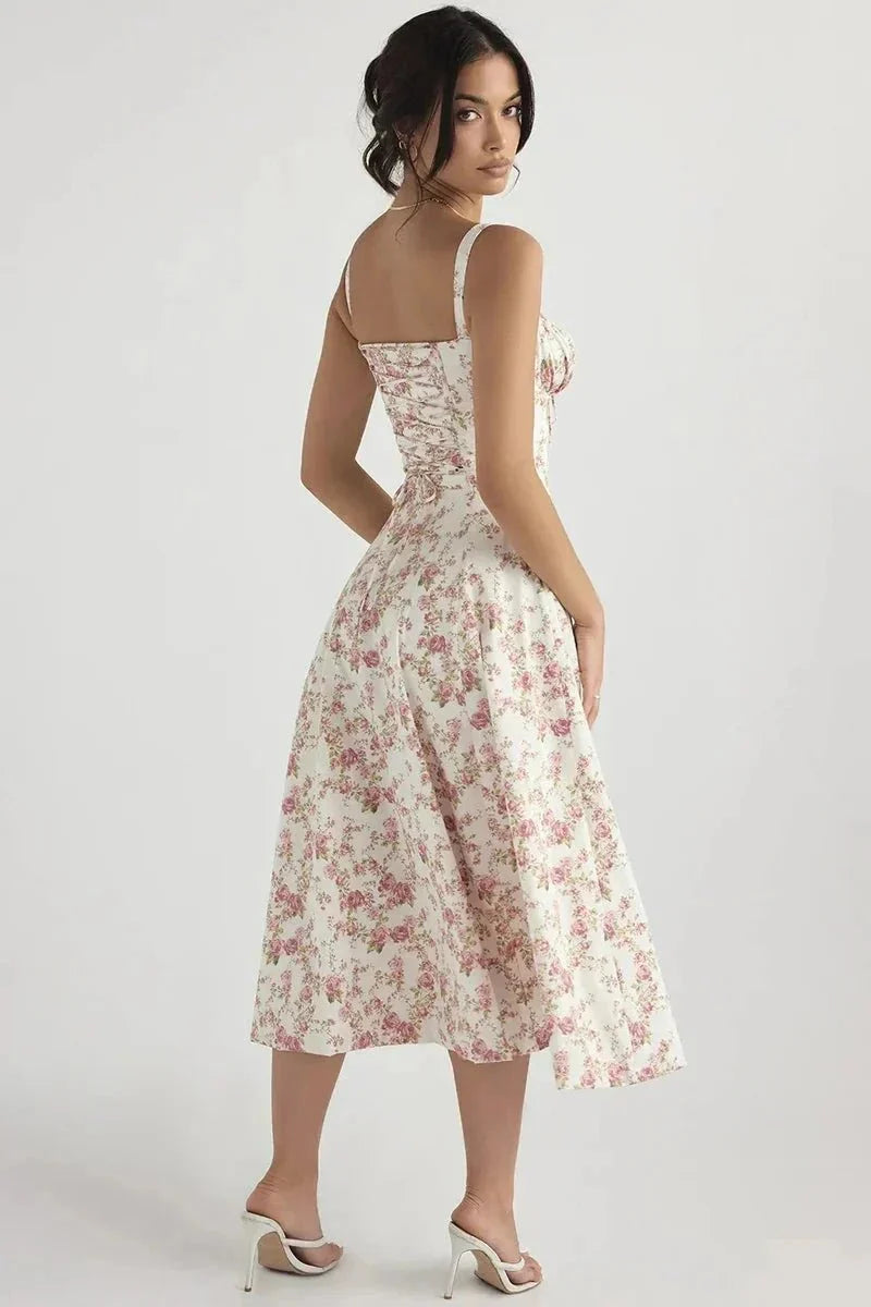Back view of white floral midi dress with pink flowers, straps, and flared midi skirt
