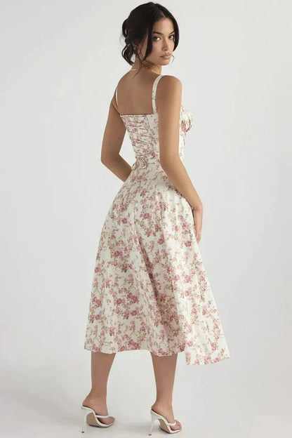 Back view of white floral midi dress with pink flowers, straps, and flared midi skirt