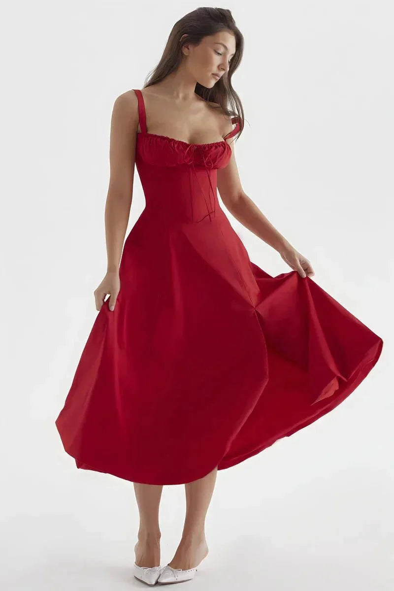 Red midi dress held out to show full skirt, fitted bodice, and shoulder straps