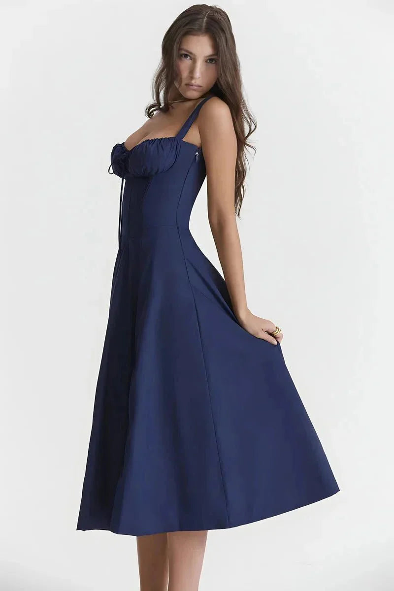 Side view of navy blue midi dress with fitted bodice and flowing A-line skirt