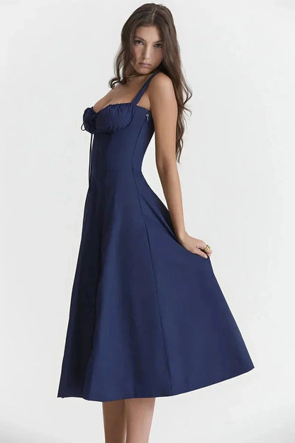 Side view of navy blue midi dress with fitted bodice and flowing A-line skirt