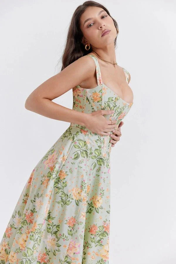 Side view of green floral off shoulder midi dress with corset bodice and flowing skirt