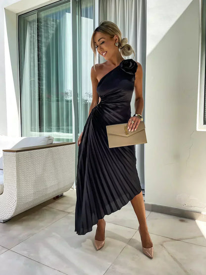 Black one shoulder pleated midi dress shown from the back with draped asymmetrical hem
