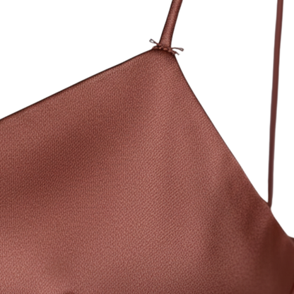 Back view of rust satin slip dress with crisscross spaghetti straps and open back