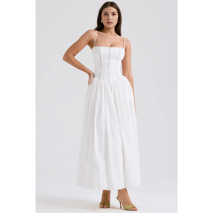 White floral maxi dress with spaghetti straps, fitted bodice, and flowing skirt