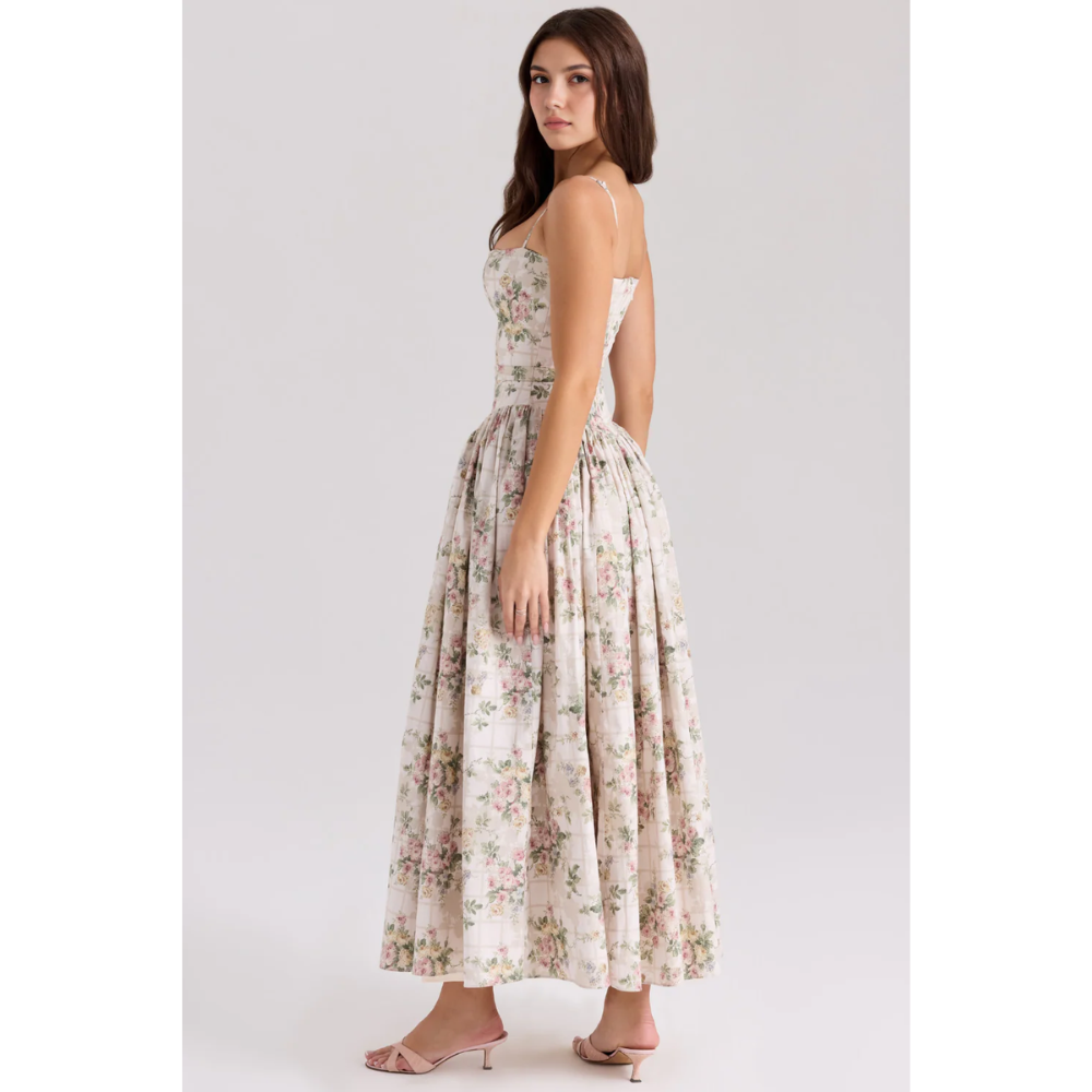 Side view of floral summer dress showing fitted waist and voluminous maxi skirt
