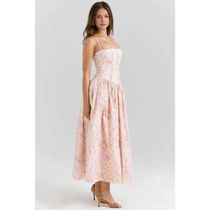 Women's pastel floral maxi dress with spaghetti straps, fitted waist, and soft pink print