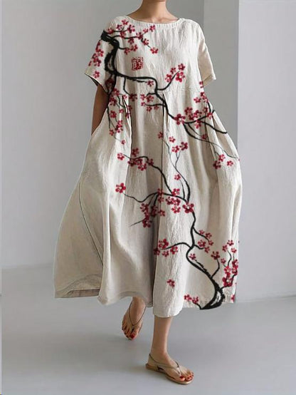 White floral midi dress with black branch print and red blossoms, loose summer dress