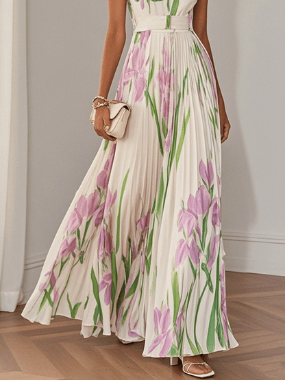 Midsection view of women's summer floral maxi dress with pleated skirt and pink green botanical print