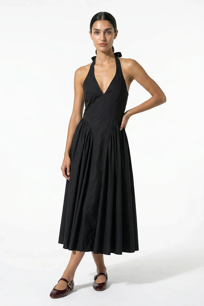 Black halter midi dress with deep V neckline and full pleated skirt, front view