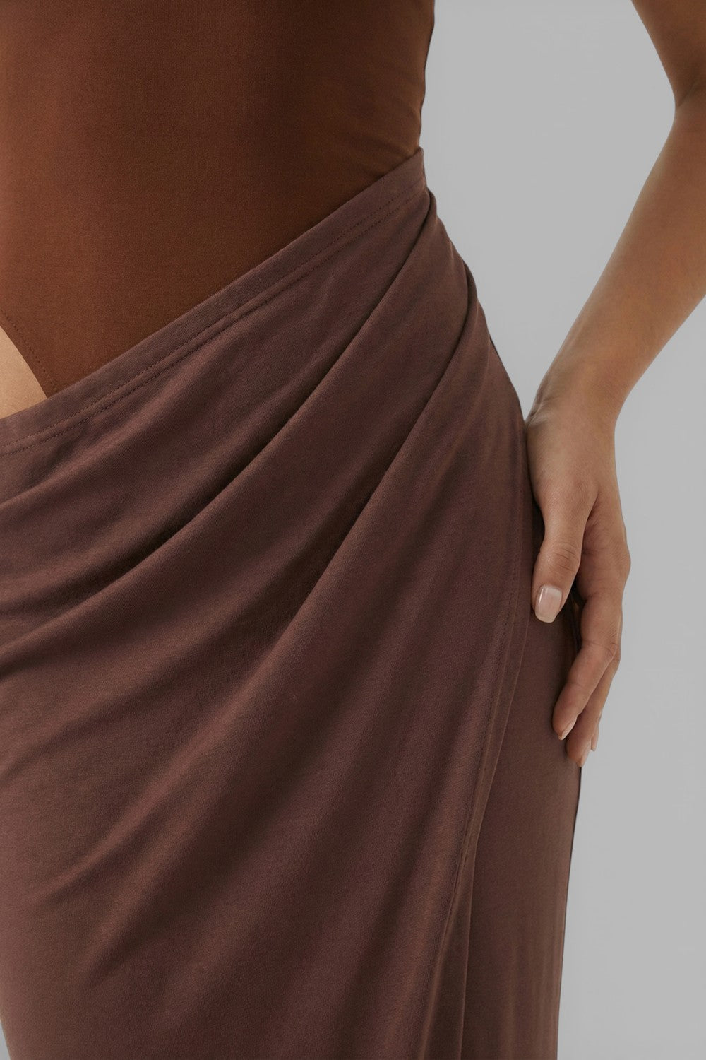 Close-up of brown summer dress showing draped waist and side cut out detail
