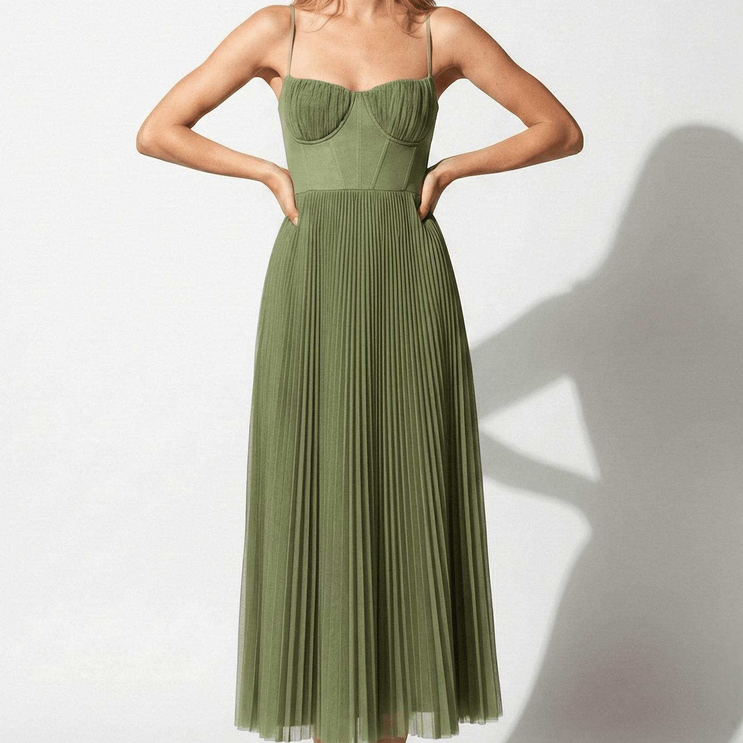 Front view of olive green pleated midi dress with corset-style bodice and straps