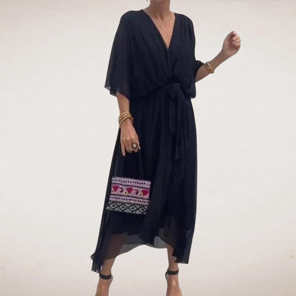 Black midi wrap dress with V neck, sheer flowing sleeves, and relaxed summer silhouette