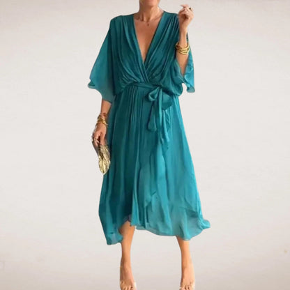 Teal midi wrap dress with deep V neck, tied waist, and soft flutter sleeves