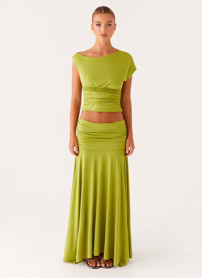 Front full-length view of lime green summer dress with boat neck, ruched bodice, and long skirt