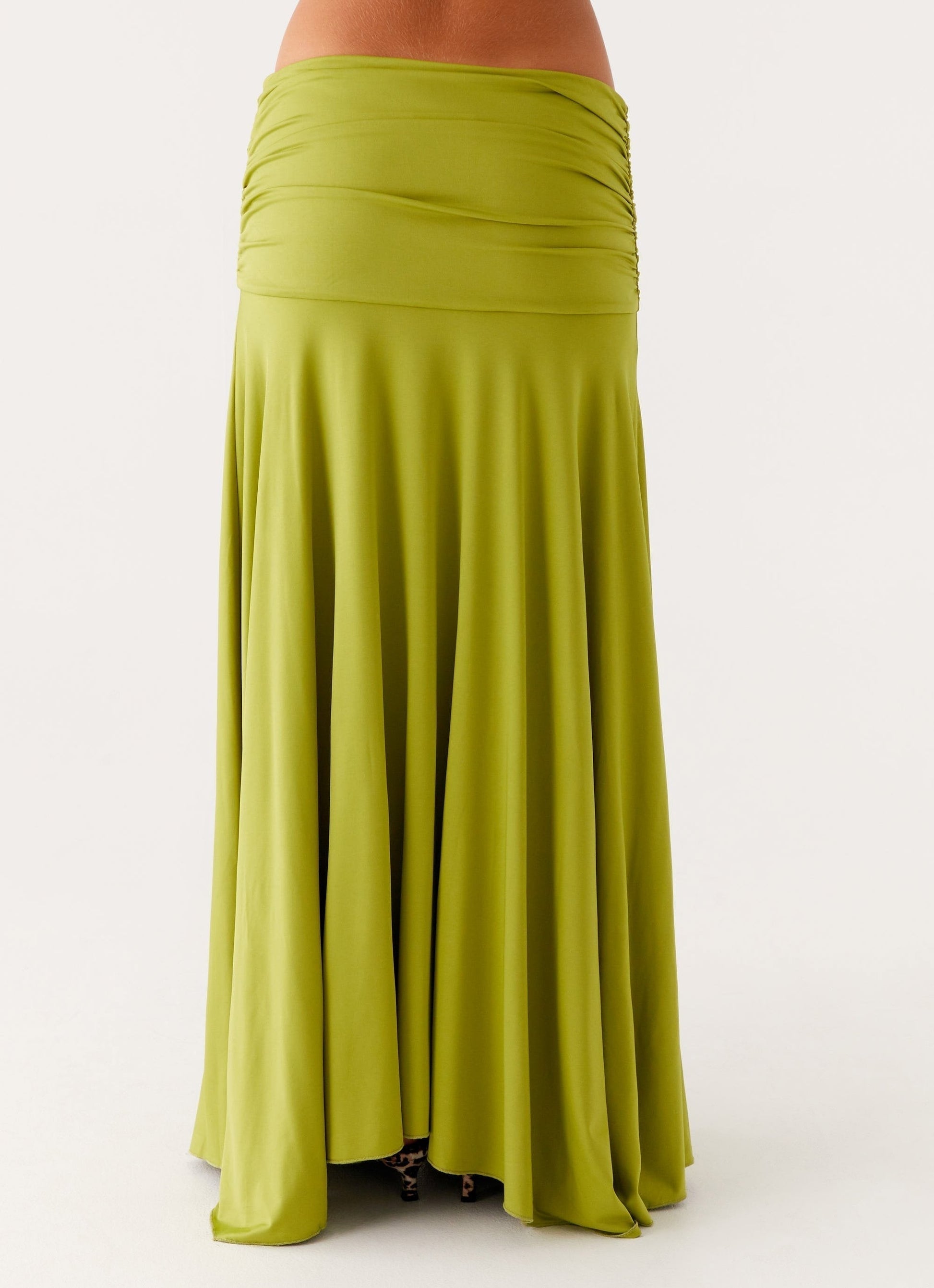 Back close-up of lime green maxi dress showing ruched waist panel and flowing skirt fabric