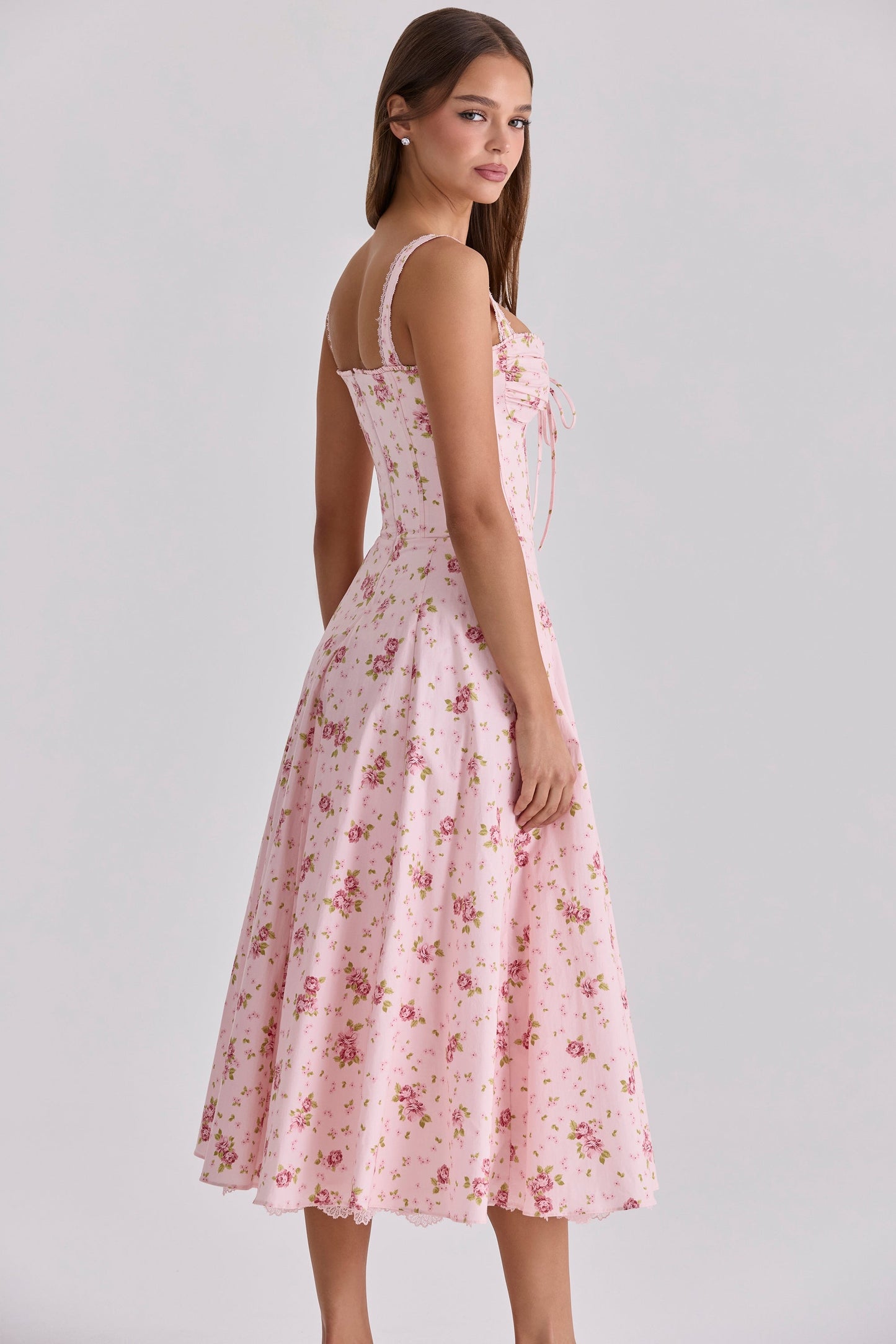 Side view of pink floral midi dress with sweetheart neckline and fitted waist