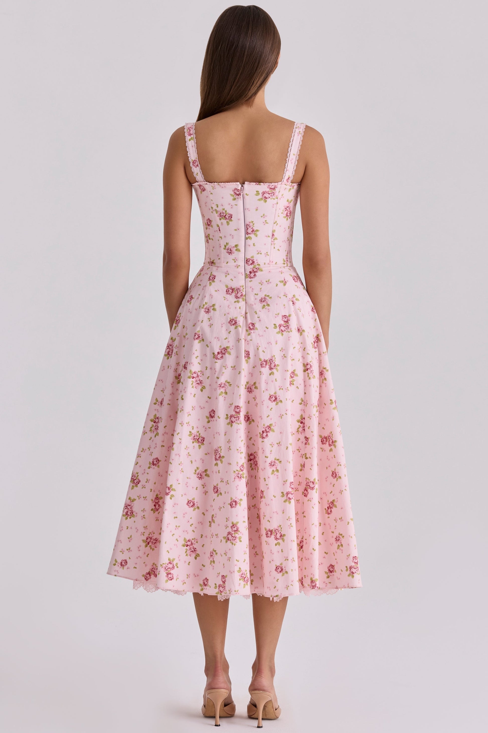 Back view of pink floral wedding guest midi dress with lace straps and full skirt