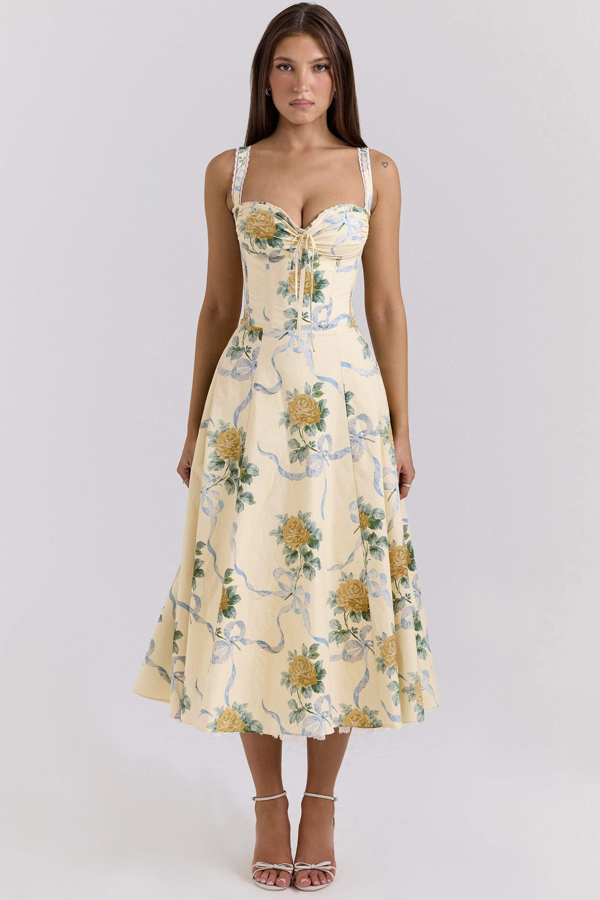 Side view of cream floral wedding guest dress with corset bodice and midi length skirt