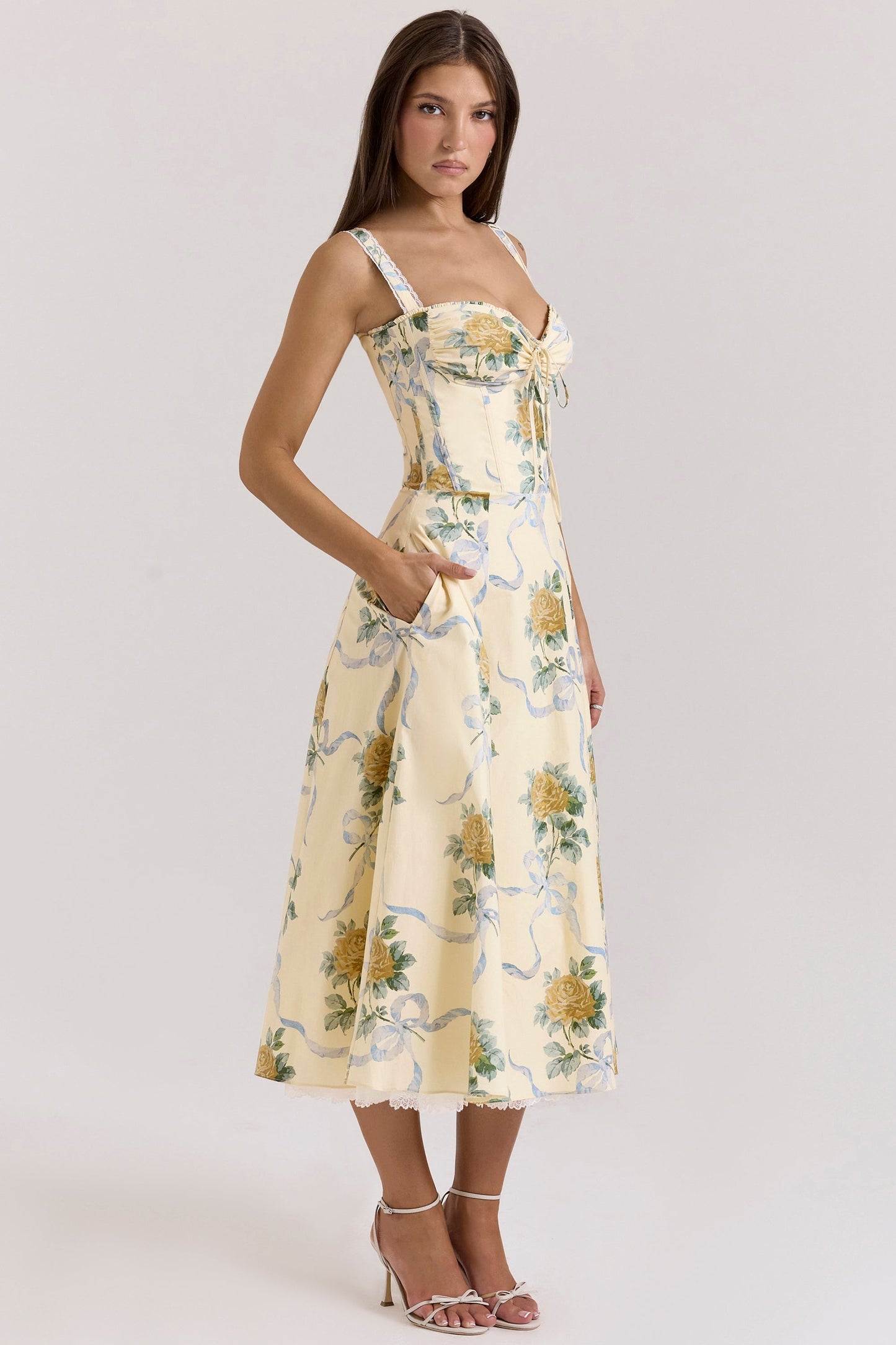Back view of cream floral midi dress with lace straps, zipper closure, and full skirt