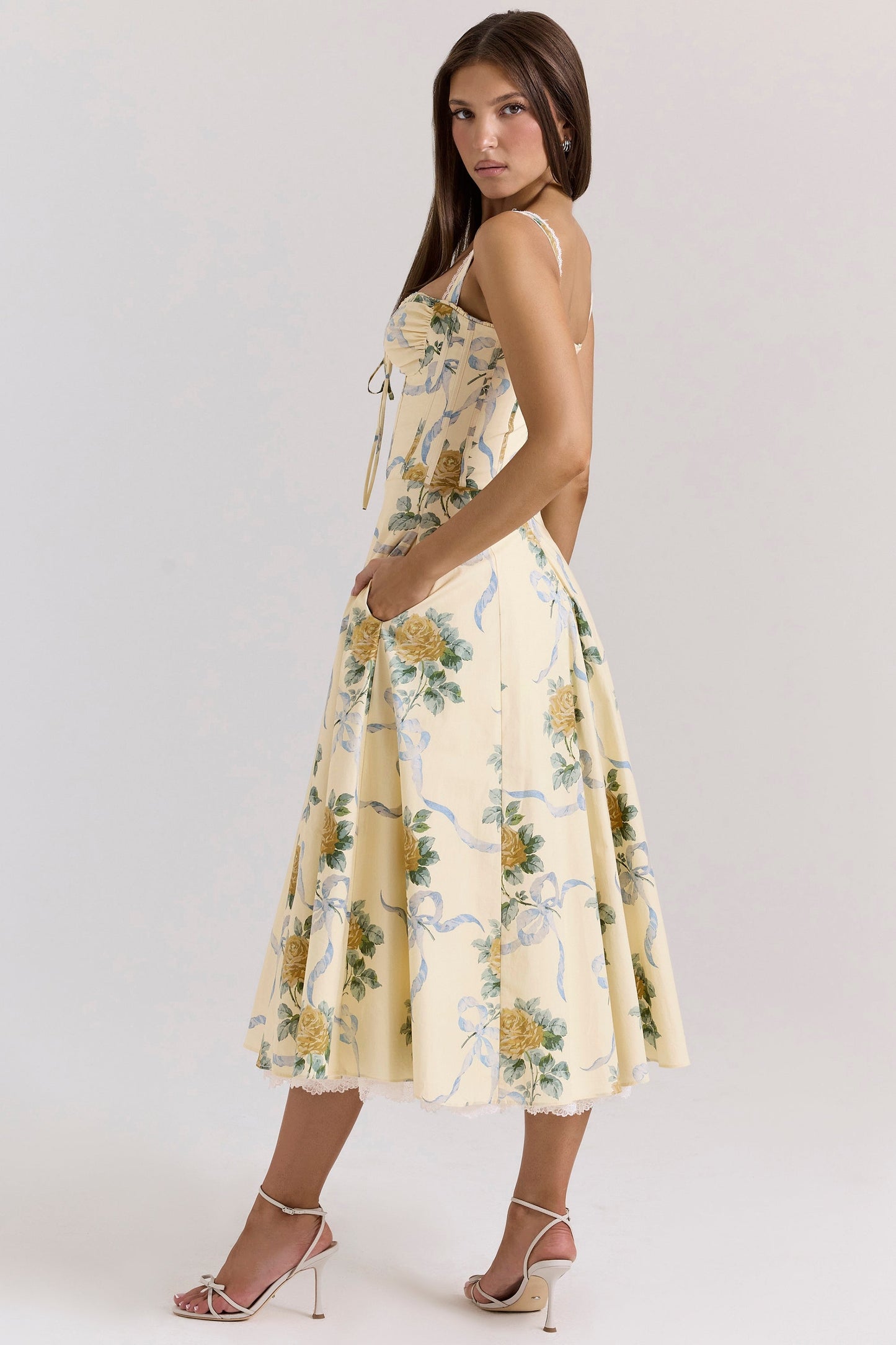 Front view of cream floral sweetheart midi dress with blue ribbon print and fitted bodice