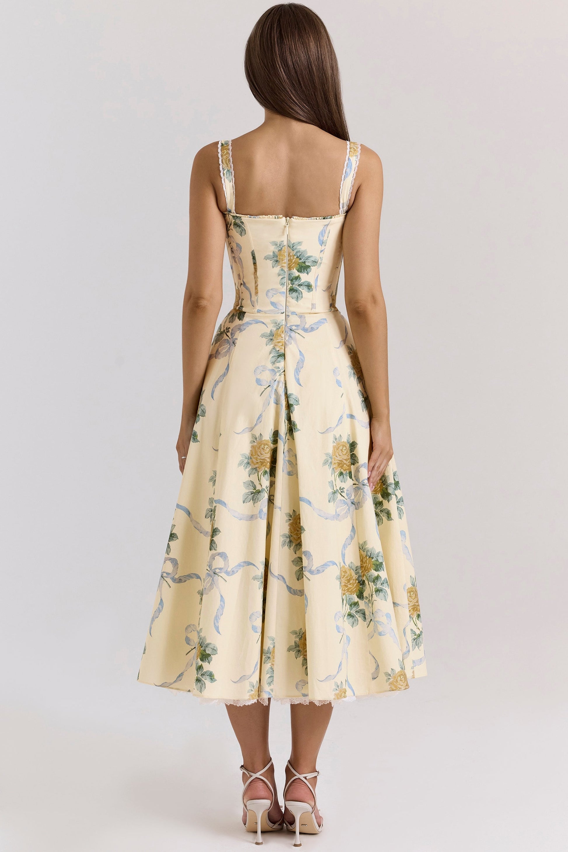Back view of cream floral midi dress with open back, lace trim, and flared wedding guest style