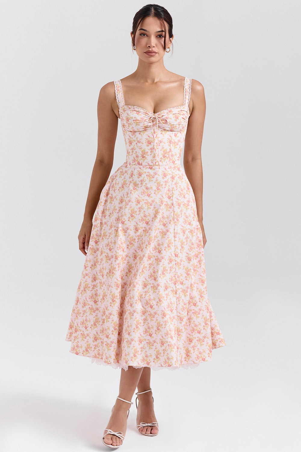 Front view of floral sweetheart midi dress with lace straps and bow detail for wedding guest wear