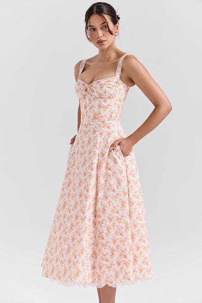 Side angle of pink floral midi dress with sweetheart neckline and fitted bodice for wedding guest outfit