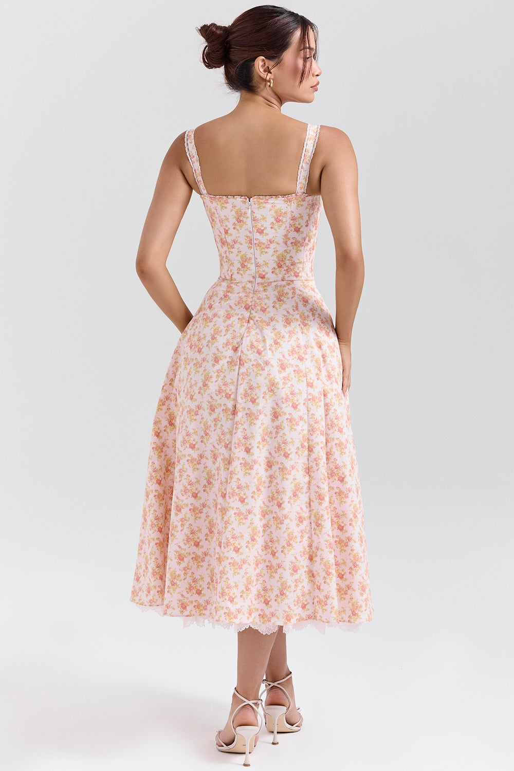 Floral midi dress shown with gathered skirt lifted to reveal lace trim and layered hem detail