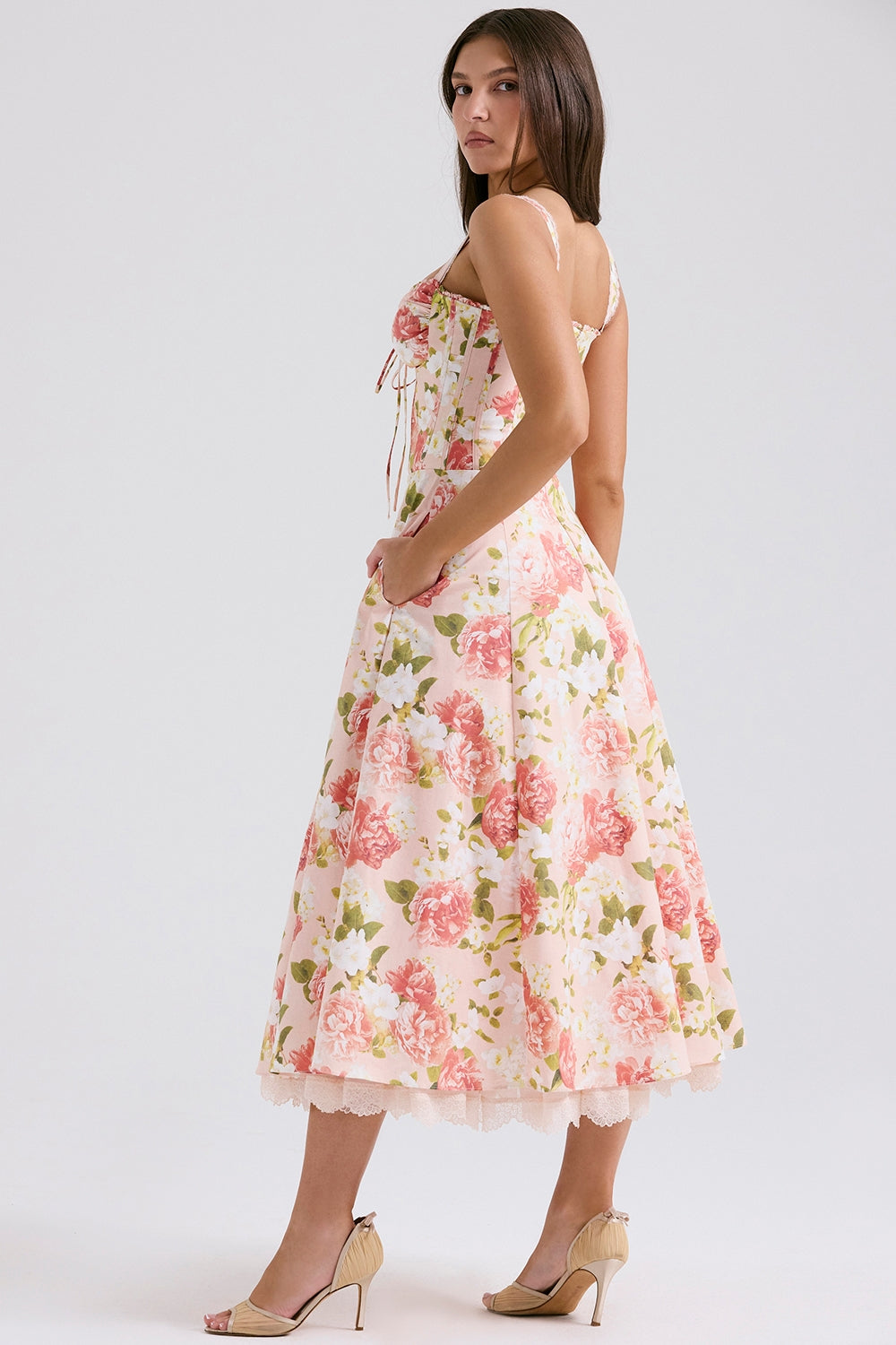 Front view of bold floral midi dress with sweetheart neckline, fitted waist, and side pockets