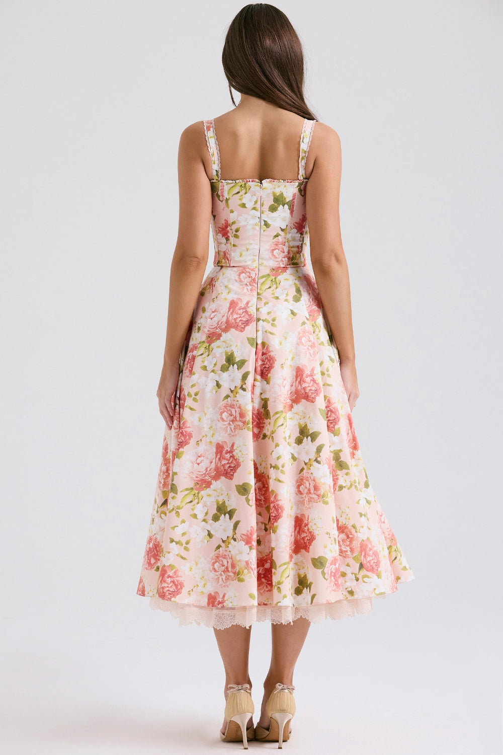Side view of floral wedding guest midi dress with corset-style bodice and full skirt