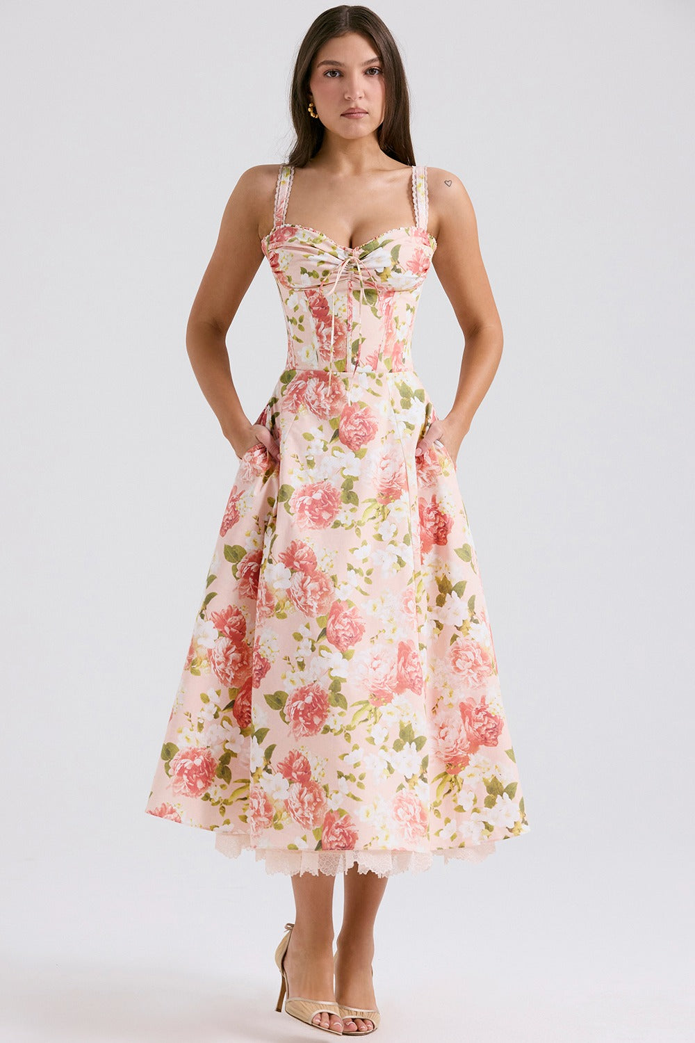 Back view of floral midi dress with fitted bodice, flared skirt, and lace hem peeking out