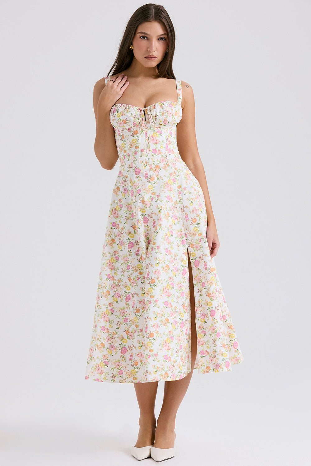 Front view of white floral midi dress with sweetheart neckline, slit skirt, and straps