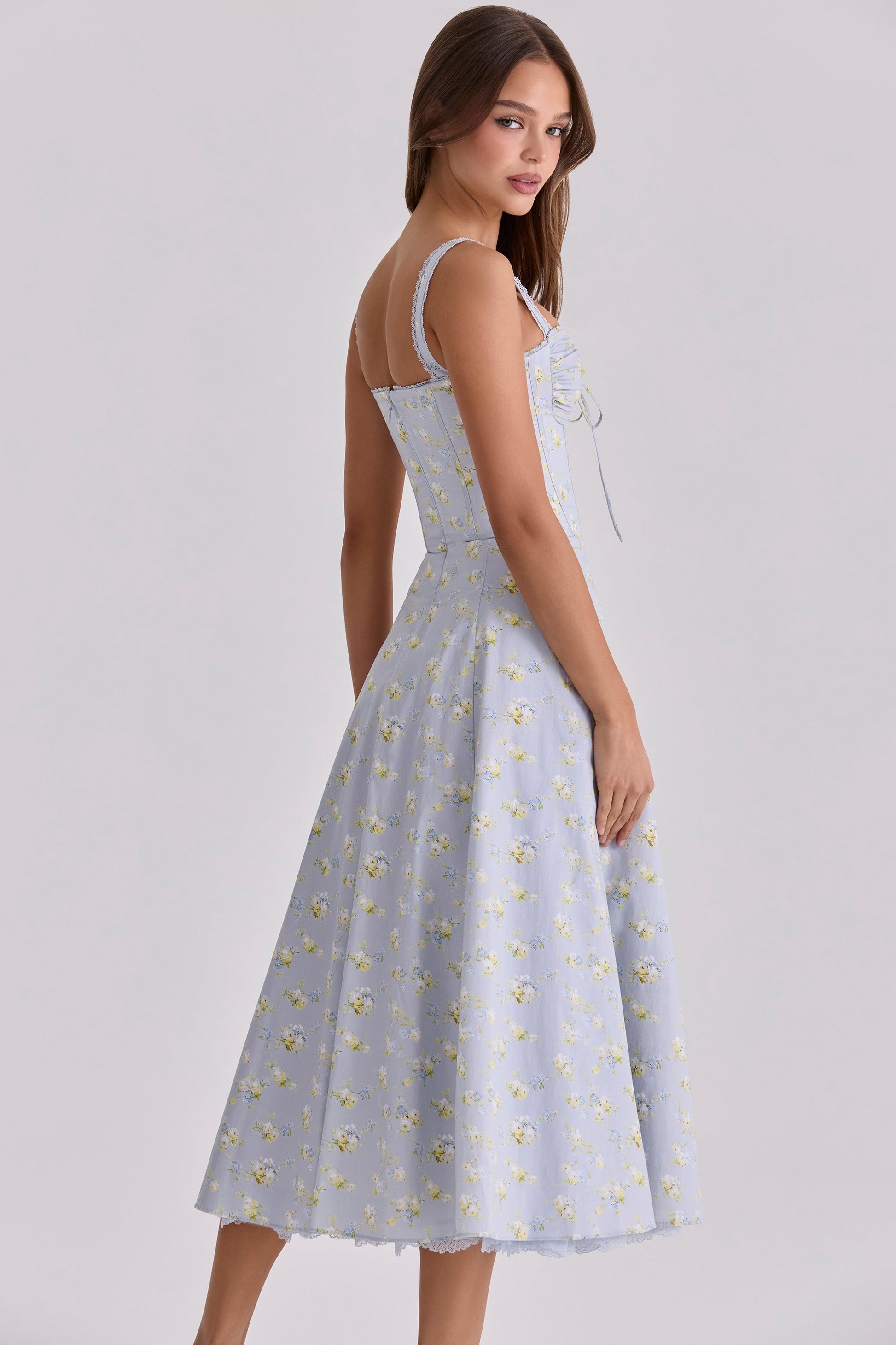 Back view of light blue floral wedding guest dress with fitted bodice and midi hem