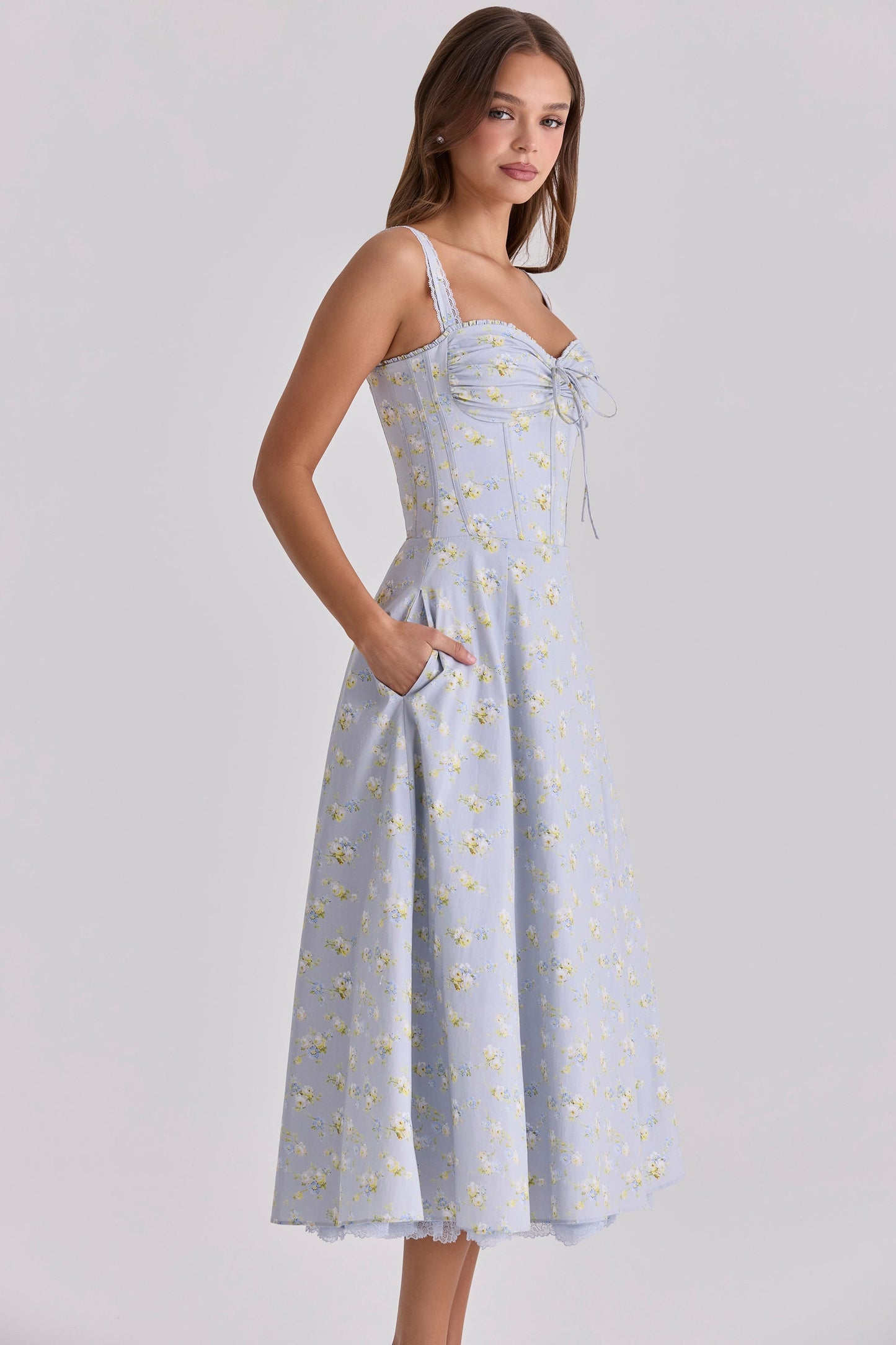 Front view of pink floral sweetheart midi dress with ruched bust and straps