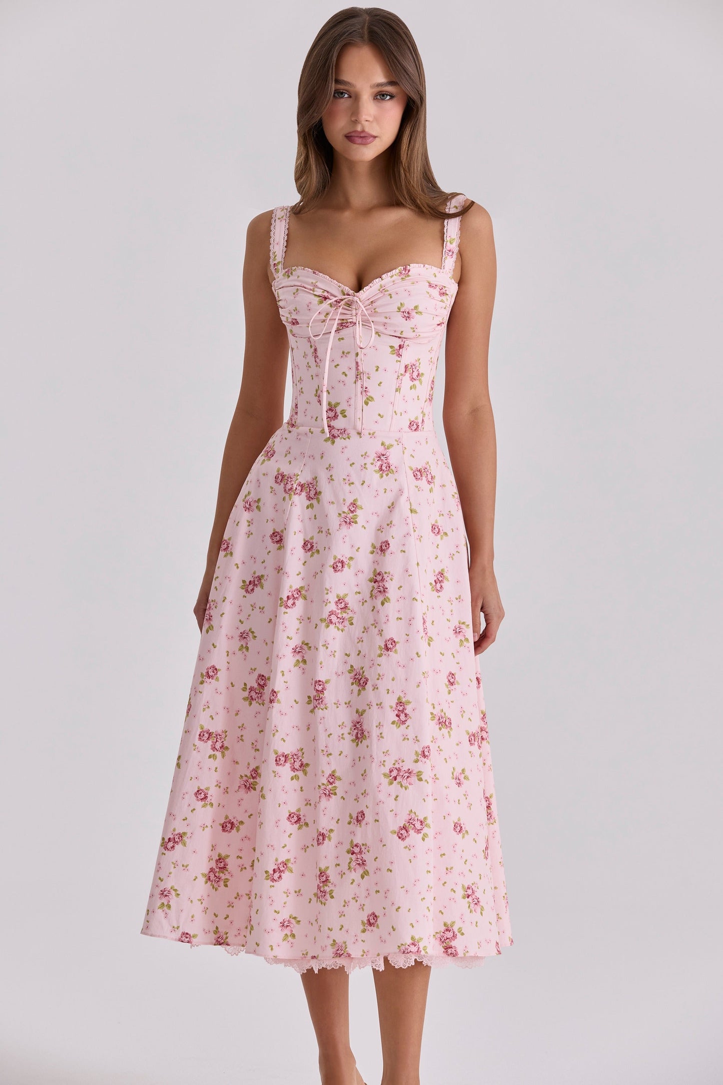 Front view of pink floral midi dress with sweetheart neckline, lace trim, and full skirt