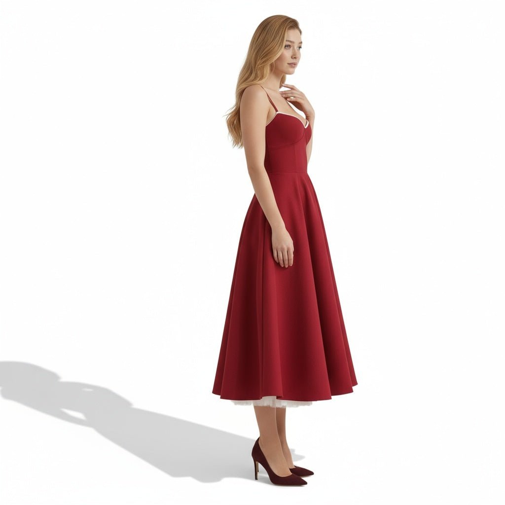 Side view of a burgundy wedding guest midi dress with flared skirt and shoulder straps