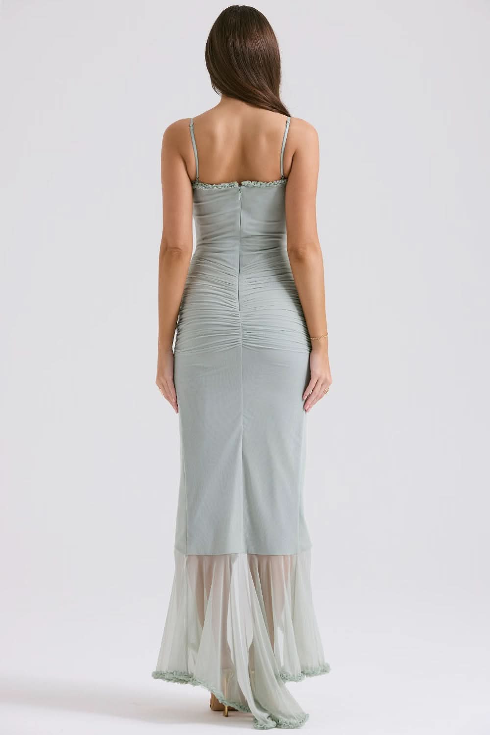Back view of sage sheer maxi dress with fitted waist and ruffle hem
