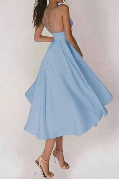 Back view of light blue V neck midi dress with open back and strappy heels
