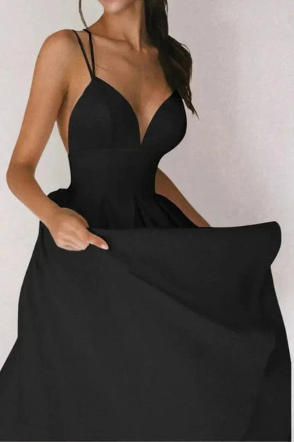 Black V neck open back midi dress with thin straps and full skirt for wedding guest